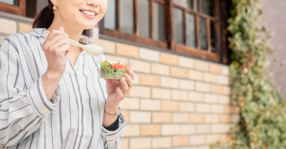 笑顔で食事をする女性の写真